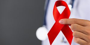 the doctor holds red ribbon hiv awareness awareness world aids day and world sexual health day